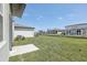 Spacious backyard showcasing a lush green lawn, perfect for outdoor activities at 1852 Brekey Way, Zephyrhills, FL 33541