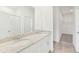 Bright bathroom with dual sinks, granite countertop, and a glass-enclosed shower at 1852 Brekey Way, Zephyrhills, FL 33541