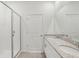 Bathroom featuring dual sinks, granite countertop, and glass enclosed shower at 1852 Brekey Way, Zephyrhills, FL 33541