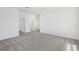 Spacious bedroom with neutral carpet and multiple doorways, offering an open layout at 1852 Brekey Way, Zephyrhills, FL 33541