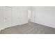 Neutral bedroom featuring carpet, and a closet with sliding doors at 1852 Brekey Way, Zephyrhills, FL 33541