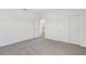 Neutral bedroom with carpet, a closet and an open doorway leading to the bathroom at 1852 Brekey Way, Zephyrhills, FL 33541