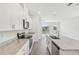 Modern kitchen showcasing white cabinets, granite countertops, stainless steel appliances, and an eat-in island at 1852 Brekey Way, Zephyrhills, FL 33541