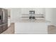 Modern kitchen with stainless steel appliances, granite countertops, and an island with a sink at 1852 Brekey Way, Zephyrhills, FL 33541