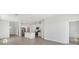 Bright open-plan living room and kitchen with stainless steel appliances and tile flooring at 1852 Brekey Way, Zephyrhills, FL 33541