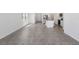 Open-concept living area featuring tile flooring, ample natural light, and seamless flow to the kitchen at 1852 Brekey Way, Zephyrhills, FL 33541
