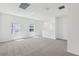 Bright, carpeted loft area with multiple windows, offering ample natural light and space at 1852 Brekey Way, Zephyrhills, FL 33541