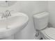 Simple powder room featuring a white sink and toilet, providing a clean and functional space for guests at 1852 Brekey Way, Zephyrhills, FL 33541
