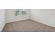 Cozy bedroom featuring neutral carpet, trim, and natural light at 1860 Brekey Way, Zephyrhills, FL 33541