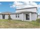Backyard featuring a covered patio and grass at 1867 Draughton Dr, Zephyrhills, FL 33541