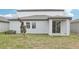 Backyard of the home with a covered patio area at 1867 Draughton Dr, Zephyrhills, FL 33541