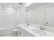 Bright bathroom featuring double sinks, white cabinetry, and a shower-tub combo with modern fixtures at 1867 Draughton Dr, Zephyrhills, FL 33541