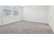 Carpeted bedroom with ample natural light and doorway at 1867 Draughton Dr, Zephyrhills, FL 33541