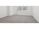 Bedroom with plush carpeting and natural light at 1867 Draughton Dr, Zephyrhills, FL 33541