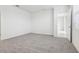Spacious carpeted bedroom with an en-suite entry at 1867 Draughton Dr, Zephyrhills, FL 33541