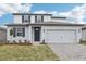 Charming two-story home with neutral paint, complemented by a two-car garage and landscaped yard at 1867 Draughton Dr, Zephyrhills, FL 33541
