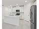 Bright kitchen with recessed lights, white cabinets, and stainless steel appliances at 1867 Draughton Dr, Zephyrhills, FL 33541