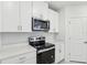 Modern kitchen with stainless steel appliances and white cabinetry at 1867 Draughton Dr, Zephyrhills, FL 33541