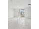 Bright living room with a sliding glass door and tile flooring throughout at 1867 Draughton Dr, Zephyrhills, FL 33541