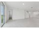 Spacious living room featuring tile flooring and sliding glass door to the backyard at 1867 Draughton Dr, Zephyrhills, FL 33541
