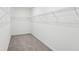 Spacious walk-in closet with carpeted floor and white shelving at 1867 Draughton Dr, Zephyrhills, FL 33541