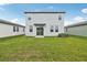 A well-maintained lawn and a two-story house create a charming backyard space, ideal for relaxation and outdoor activities at 1868 Brekey Way, Zephyrhills, FL 33541