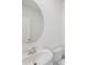 Modern bathroom with a white vessel sink, chrome faucet, and round mirror at 1868 Brekey Way, Zephyrhills, FL 33541