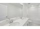 Bright bathroom with double sinks, quartz countertop, and tiled shower/tub combo at 1868 Brekey Way, Zephyrhills, FL 33541