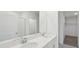 Bathroom features dual sinks with quartz countertops and modern fixtures at 1868 Brekey Way, Zephyrhills, FL 33541