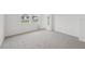 Bedroom with new carpeting, natural light, and a view of the neighborhood at 1868 Brekey Way, Zephyrhills, FL 33541