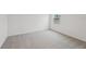 Neutral bedroom with neutral carpet and a window letting in natural light at 1868 Brekey Way, Zephyrhills, FL 33541