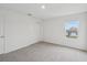 Bright bedroom with neutral carpet, closet and a window overlooking the neighborhood at 1868 Brekey Way, Zephyrhills, FL 33541