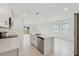 Bright and modern kitchen with stainless steel appliances, a center island, and tiled flooring at 1868 Brekey Way, Zephyrhills, FL 33541