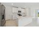 Clean, contemporary kitchen with white cabinetry, stainless steel appliances, and a center island at 1868 Brekey Way, Zephyrhills, FL 33541