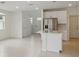 Well-lit kitchen featuring stainless steel appliances, a breakfast bar, and sleek white cabinets at 1868 Brekey Way, Zephyrhills, FL 33541