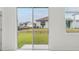 Bright living room with glass sliding door, windows with view of backyard at 1868 Brekey Way, Zephyrhills, FL 33541