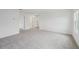 Bright, open living room featuring neutral carpet and ample natural light at 1868 Brekey Way, Zephyrhills, FL 33541