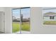 Bright interior view highlighting a large sliding glass door overlooking the backyard at 1868 Brekey Way, Zephyrhills, FL 33541