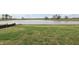 Expansive backyard with lush green grass, offering plenty of space for outdoor activities, with a serene lake view at 1886 Draughton Dr, Zephyrhills, FL 33541