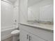 Clean bathroom features white vanity with sink and bath with tile surround at 1886 Draughton Dr, Zephyrhills, FL 33541