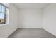 Empty bedroom showcasing a bright window, neutral carpet, and a blank canvas for customization at 1886 Draughton Dr, Zephyrhills, FL 33541