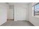 Bright bedroom includes carpet, a bright window, and a closet for plenty of storage space at 1886 Draughton Dr, Zephyrhills, FL 33541