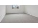 Cozy bedroom with plush carpet and a large window offering a view of the outdoors at 1886 Draughton Dr, Zephyrhills, FL 33541