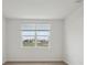 Bright bedroom features a double window with green outdoor view and neutral paint at 1886 Draughton Dr, Zephyrhills, FL 33541