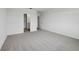 Inviting bedroom featuring neutral carpet, closet, and ensuite bathroom at 1886 Draughton Dr, Zephyrhills, FL 33541