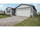 Charming single-story home with stone accents and a well-manicured lawn at 1886 Draughton Dr, Zephyrhills, FL 33541