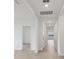 Bright hallway with wood floors, recessed lighting, and white walls leading to bedrooms and living areas at 1886 Draughton Dr, Zephyrhills, FL 33541