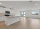 Modern kitchen featuring an island, stainless steel appliances, and light wood floors at 1886 Draughton Dr, Zephyrhills, FL 33541