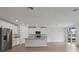 Bright, open kitchen with an island, stainless steel appliances and tiled floors at 1886 Draughton Dr, Zephyrhills, FL 33541