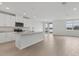 Modern kitchen featuring granite countertops, stainless steel appliances, and a large island with waterfront views at 1886 Draughton Dr, Zephyrhills, FL 33541